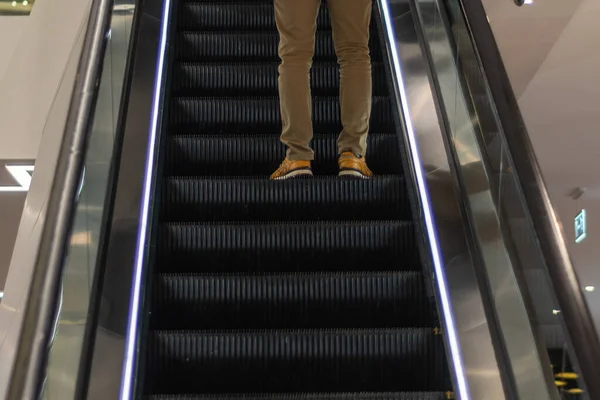 Male Legs Yellow Pants Sneakers Escalator Step — Stock Photo, Image