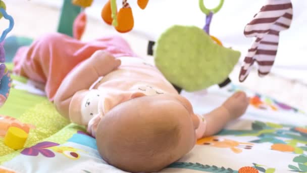 Schieten Pasgeboren Baby Meisje Liggend Bed Met Kleurrijke Speelgoed — Stockvideo