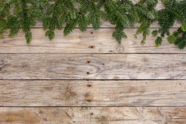 Noel kartpostal çerçevesi, tebrik kartı için ahşap arka plan. Yeşil köknar ağacı doğal çelenk. Xmas duvar kağıdı.