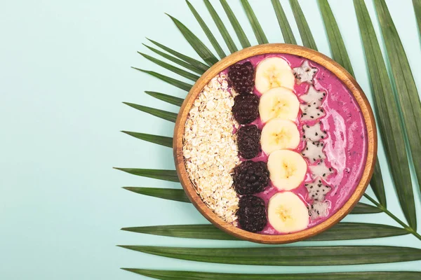 Smoothie bowl on mint background