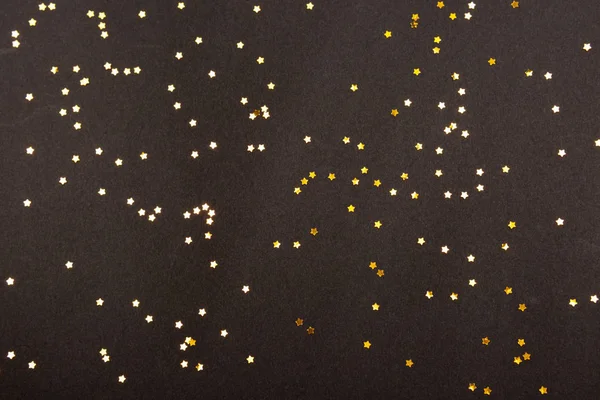 Confiti en forma de estrella sobre negro — Foto de Stock