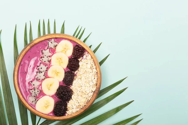 Smoothie bowl on mint background