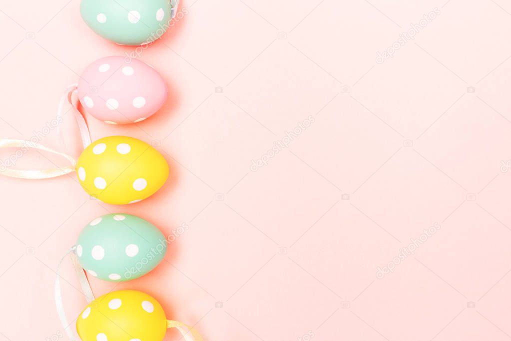 Easter eggs on pastel pink background