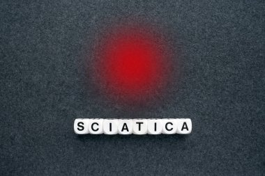 Word sciatica from white blocks and red circle dot on dark fabric background. Orthopedics, neurology pain. leg pain, tingling, numbness, weakness Sciatic Nerve. Medical concept. clipart