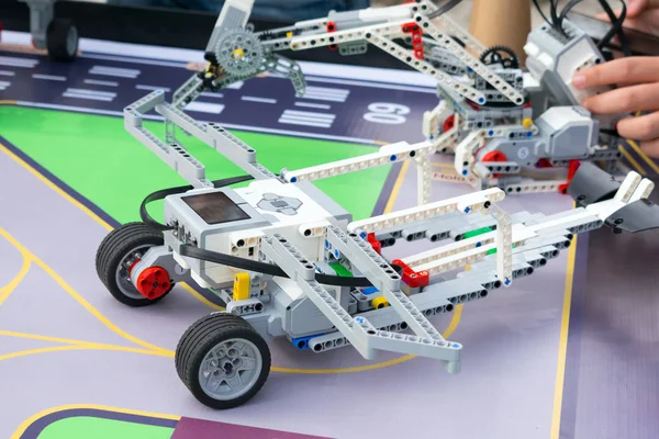 Robot Car, robotics with remote control. Fan robots with children\'s hands in the background. School Robotics learning for children. Modern training. Model kits. The hottest gadgets.