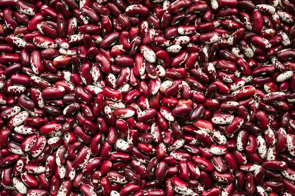 Health Benefits of Beans. Red and white beans background. Benefits for diet, weight control and diabetes.