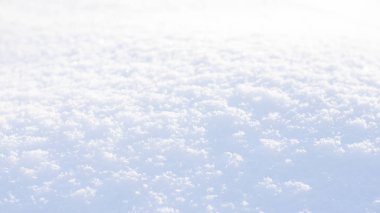 White blue snow texture background with bokeh. Close up of fresh clean snow with blue shadows. Selective focus