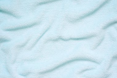 Kabarık nazik Bebek Mavisi kumaş. Yumuşak pastel Tekstil doku. Yumuşak kumaş üzerine pas geçiyor. Mavi havlu havlu kumaş.