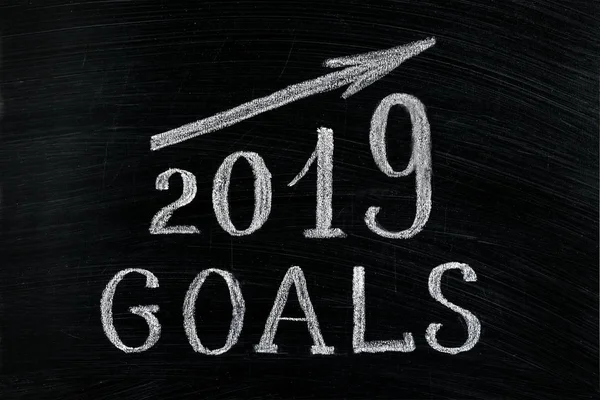 New Year 2019 goals with a rising arrow text chalk on a blackboard. Chalkboard written with text 2019 Goals. New year success in business. Plans for the year, increase in profits