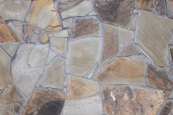 Fragment of wall from chipped stone. facing stone wall texture — Stock Photo, Image