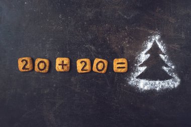 Un silueti Noel Ağacı, üzerinde 2020 rakamları var.