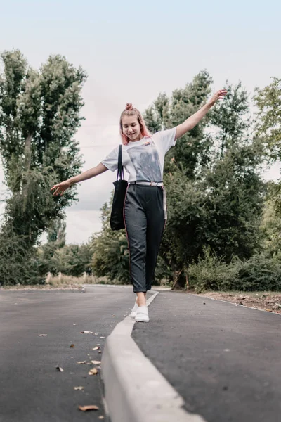 Giovane adolescente hipster ragazza con i capelli rosa va lungo il marciapiede l — Foto Stock