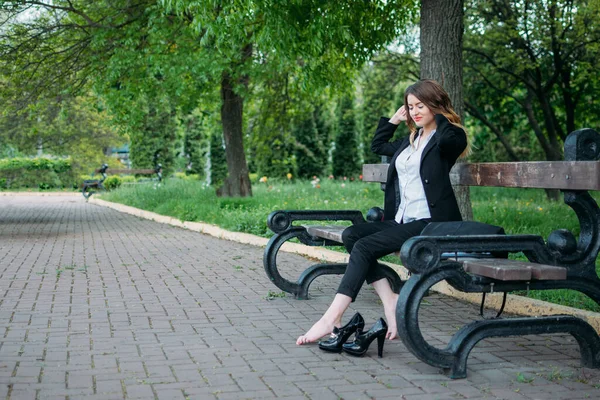 Go Barefoot Day. Young business women kick off their footwear, let feet breathe and relax after office work