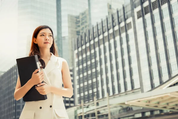 Portrait charming beautiful secretary woman. Attractive beautiful woman hold document file at street near her office. Gorgeous girl look determined. Gorgeous woman has good job. building background