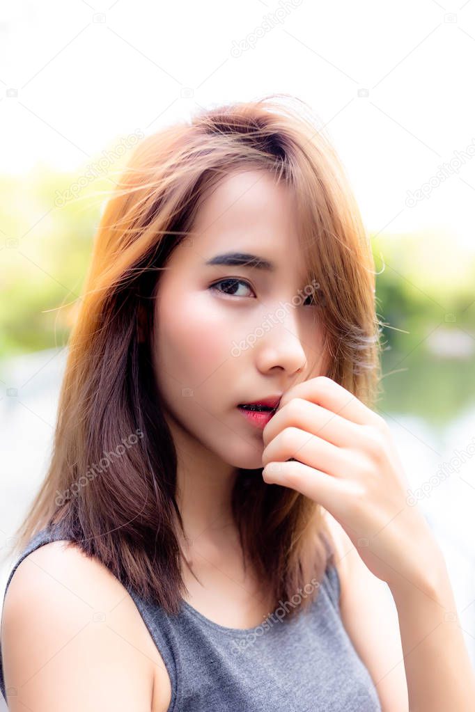 Portrait charming beautiful asian woman. Attractive Thai girl has beautiful face. Gorgeous woman looks confident. Glamour lady has honey skin and long hair. She looks so charming and relaxing