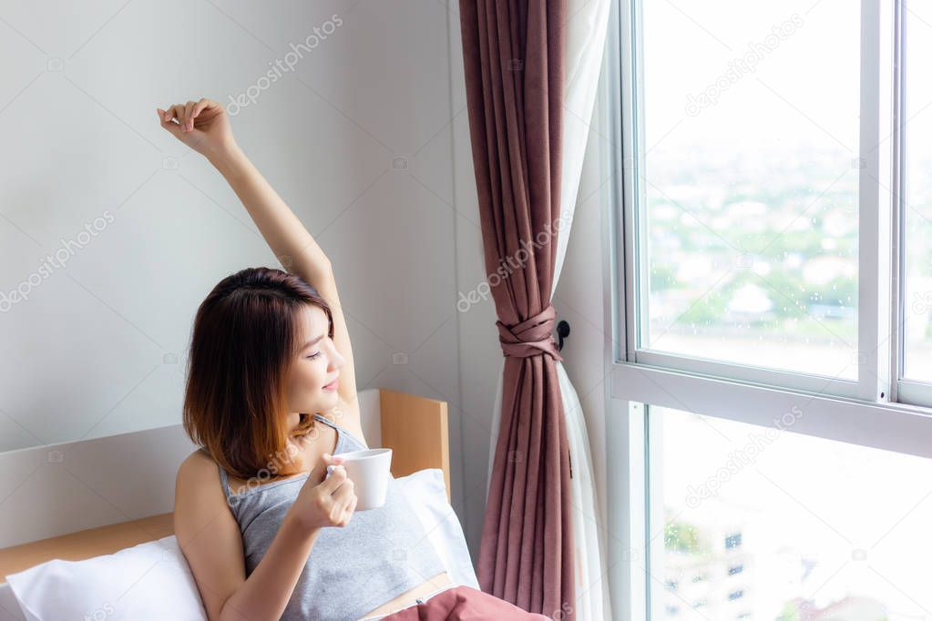 Portrait pretty young woman. Attractive beautiful girl is waking up early in the morning and lovely girl is drinking coffee that makes her fresh. Charming beautiful woman feels relaxing and happiness