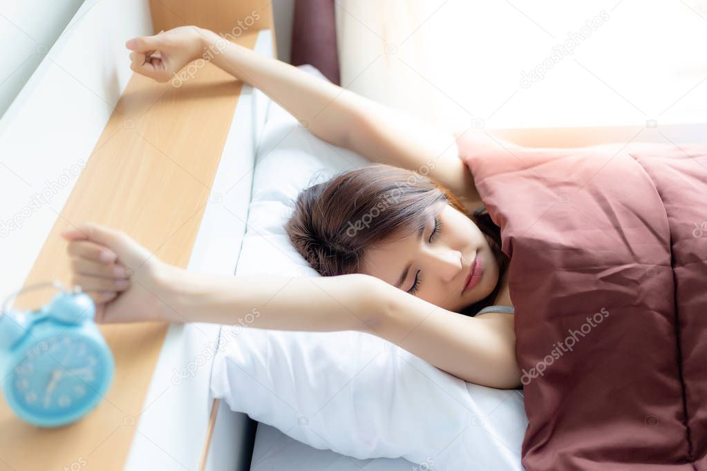 Portrait charming beautiful asian woman. Attractive beautiful woman is stretching the arms and body. Gorgeous woman is waking up in the morning on Monday morning. She has go to work but she gets lazy