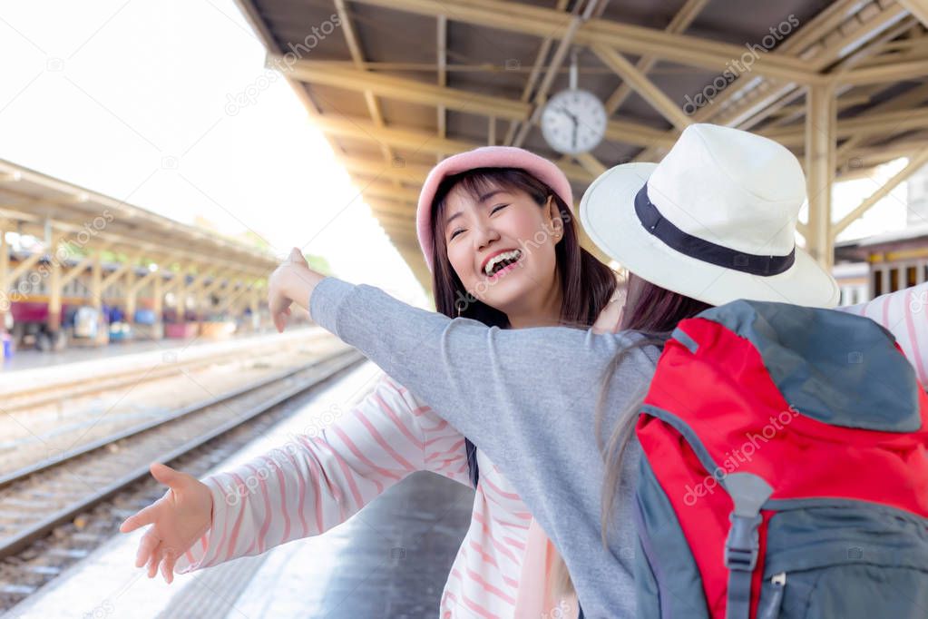 Attractive beautiful woman is coming back from working at oversea or foreign country. Pretty woman is going to embrace younger sister or friend that she does not see her for long time at train station