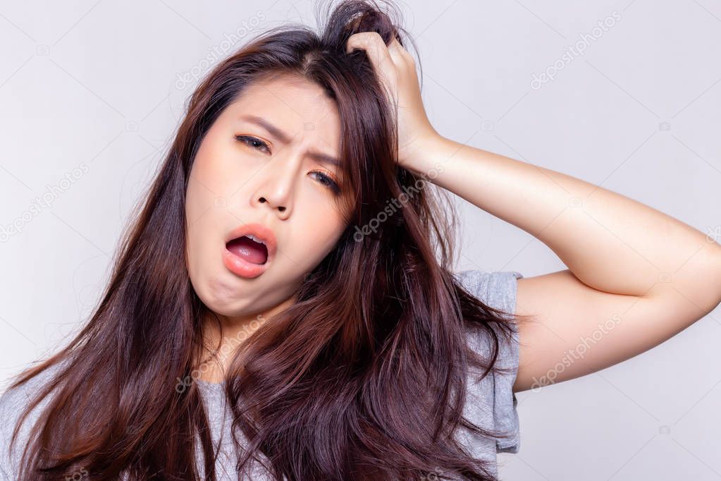 Expression concept. Beautiful young woman feel sleepy and yawning. Attractive young girl is lazy person. She does not want get up early and lazy to do everything. She get boring. She scratch her head