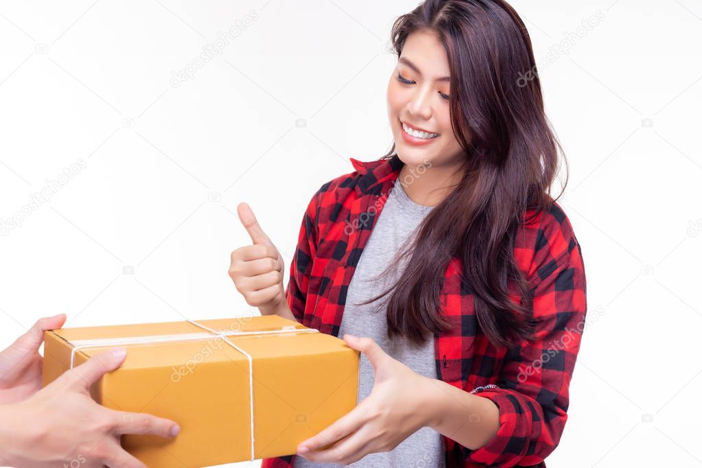 Beautiful woman receive package from goods delivery. It send from foreign country to customer woman very quickly. Attractive beautiful girl get satisfied it and give thumbs up with smile face.