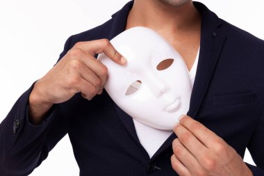 Two faced of Businessman hide white mask and put artificial mask to pocket suit. White collar worker is dishonest guy. Cheating man betray business partner, dishonest hiding in mask. Young man is spy clipart