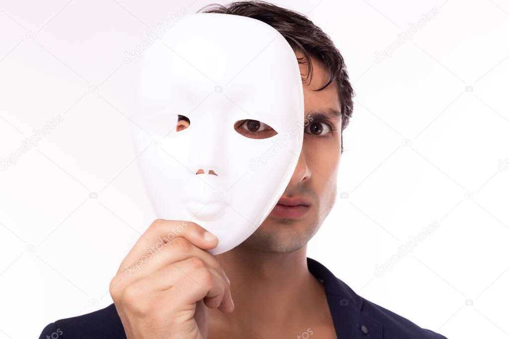 Businessman hold white mask in his hand. Man is dishonest cheating person. Faking, cheating business partnership, dishonest hiding in mask. Cheating person take off his mask and revealed the real him