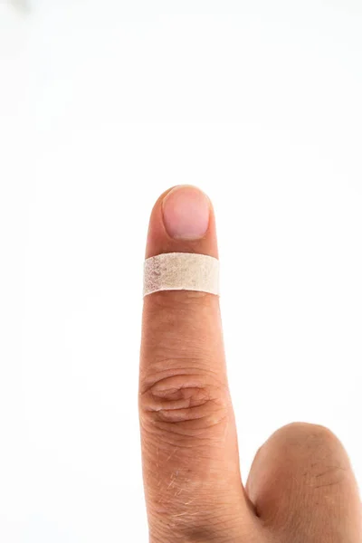 Band aid envolto em torno de um dedo masculino apontando fechar estúdio s — Fotografia de Stock