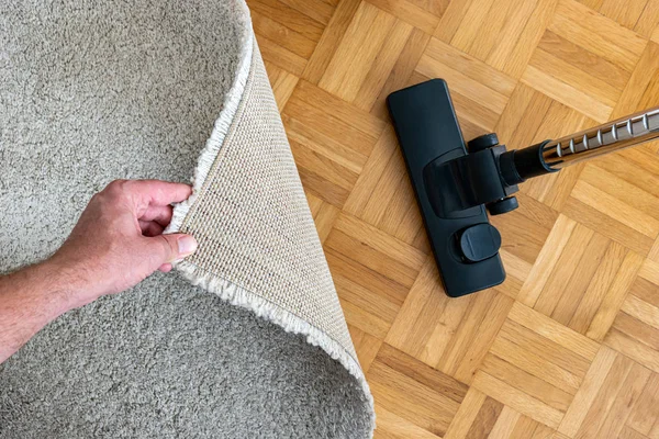 Vacuum cleaner extension on a laminated wooden floor close to a