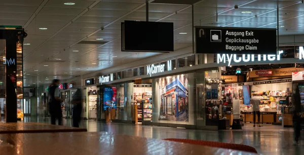 International airport duty-free shop during peak travel season unrecognizable people.