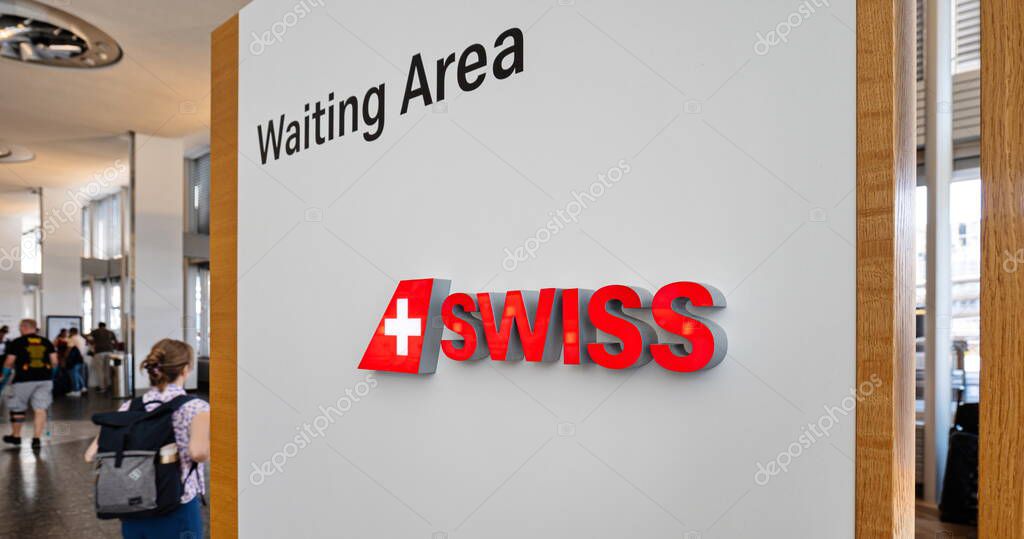 Zurich Airport, Switzerland, August 25, 2025. Swiss airline company logo on a white board designating a waiting area inside airport terminal