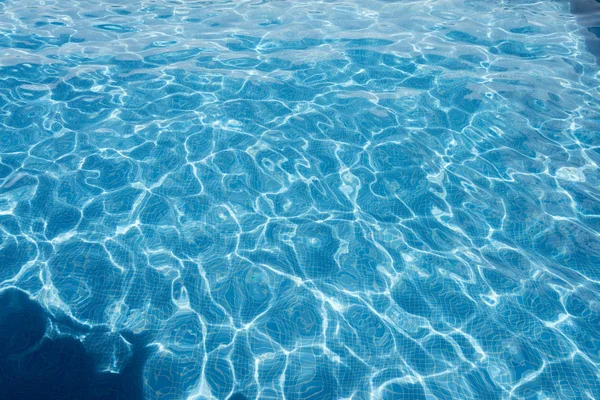 Mavi bir havuzda su üzerine güneşin düşünceler tarafından oluşturulan doku.