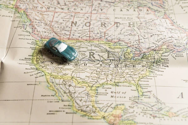 Travel concept. Toy car on map of North America.