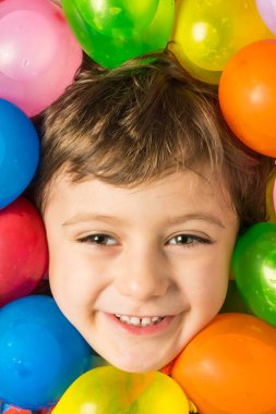 Yüzü su balonlarıyla çevrili bir çocuğun yaratıcı portresi..