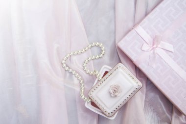 hediye kutusu ve inci boncuk ve bir gül pembe arka plan, anneler günü, aşk sembolleri