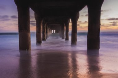 Uzun pozlama Manhattan Beach iskelesinden altından gün batımından sonra yumuşak dalgalar sahile, Manhattan Beach, Kaliforniya yıkama ile vurdu