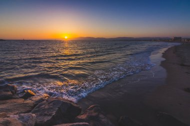 Uzun pozlama atış bir dalgalar deniz feneri plaj güneş üzerine yıkama ayarlar Santa Monica dağlar, Marina Del Rey, California