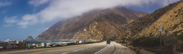 Scenic view of Southern California coast from Pacific Coast Highway with clouds covering the Santa Monica Mountain Range, Malibu, California