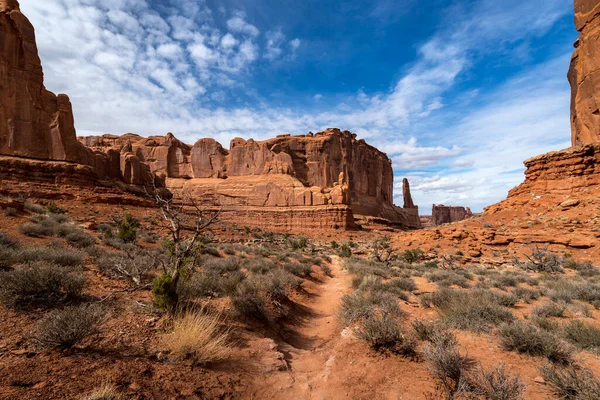 Scenic view of monolithic sandstone rock structures seen along the Park Avenue Trail with Tower of Babel in the distance, Arches National Park, Moab, Utah