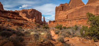 Manzaralı manzara, Park Avenue Trail, Arches National Park, Moab, Utah boyunca görülen tek taş kaya yapılarıyla çevrili bir kanyona bakıyor.