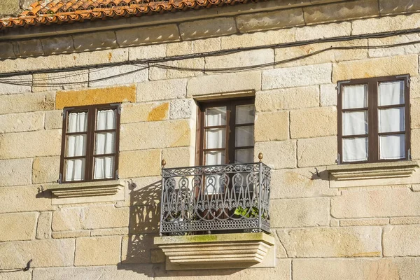 Old balcony and windows in stone building