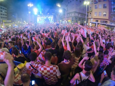 ZAGREB, CROATIA - JUNE 21 Croatian football fans on the Ban Jelacic Square, watching 2018 FIFA WORLD CUP RUSSIA match Argentina vs Croatia on June 21, 2018 in Zagreb, Croatia clipart