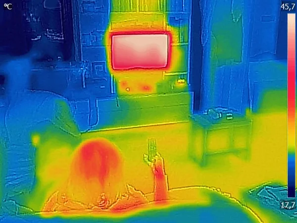 Thermal image Photo while a woman is watching television