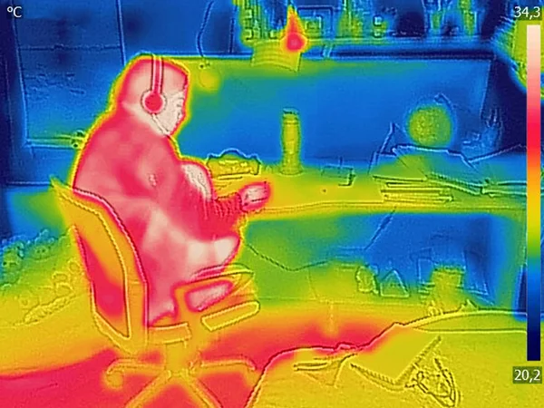 Thermal image Photo while woman listening to music on the headphones