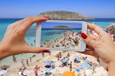 Genç kız cep telefonu ile fotoğraf arşivi Cala Conta beach Ibiza Adası, İspanya