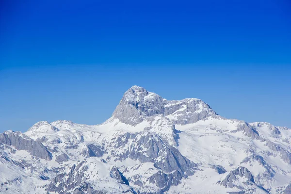 Panoramic view of the snowy mountain Triglav the highest peak of — Stock Photo, Image