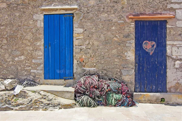 Staré dřevěné dveře a rybářské sítě v Formentera — Stock fotografie