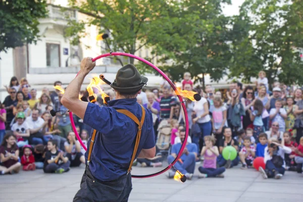 Street performer with a fire wheel — Stock Photo, Image