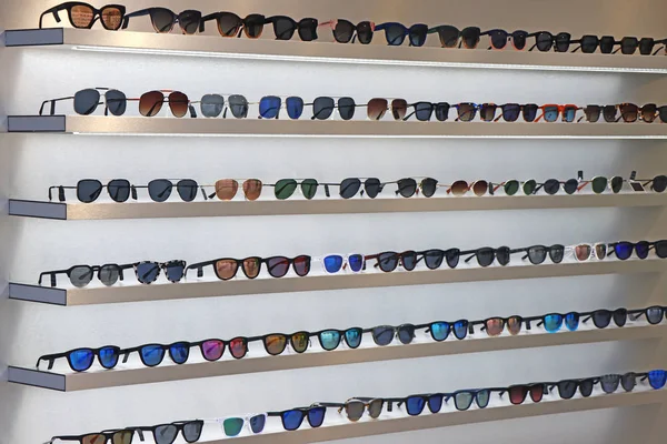 Lot of sunglasses on the wall showcase — Stock Photo, Image