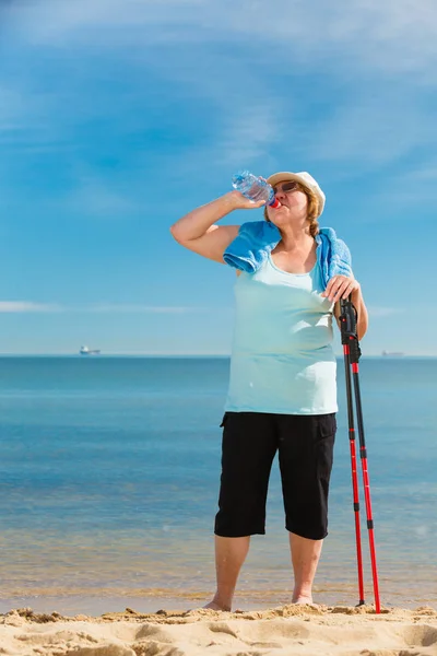 Senior Woman Practicing Nordic Walking Sea Shore Drinking Fresh Water — Stock Photo, Image