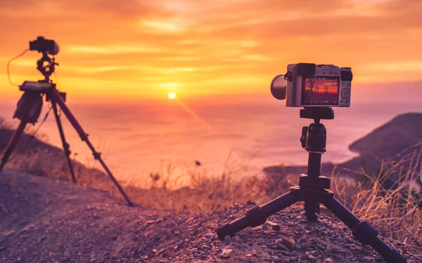 Professional camera taking picture film video of sunrise over sea surface, Greece Peloponnese Mani Peninsula.